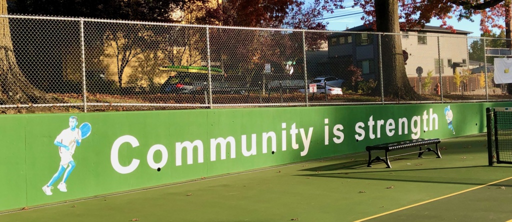 Photograph of the mural that reads Community is Strength at the Alex Rovello Memorial Foundation Courts