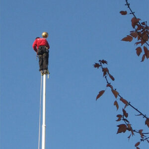 Photo of an OnRope Services worker climbing a flagpole for repair.
